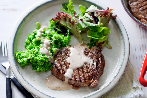 Steak with crushed peas and peppercorn sauce
